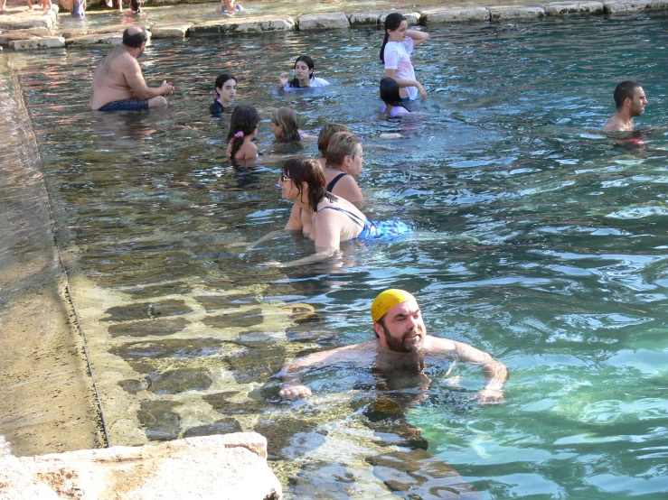 the people are in the water with towels on their heads