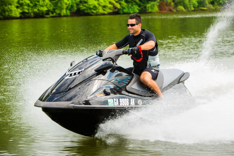 a man riding a jet ski being ridden by a boat