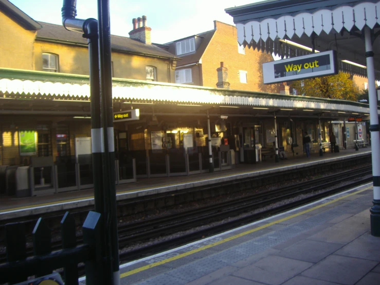 the train station is empty of people on a bright day