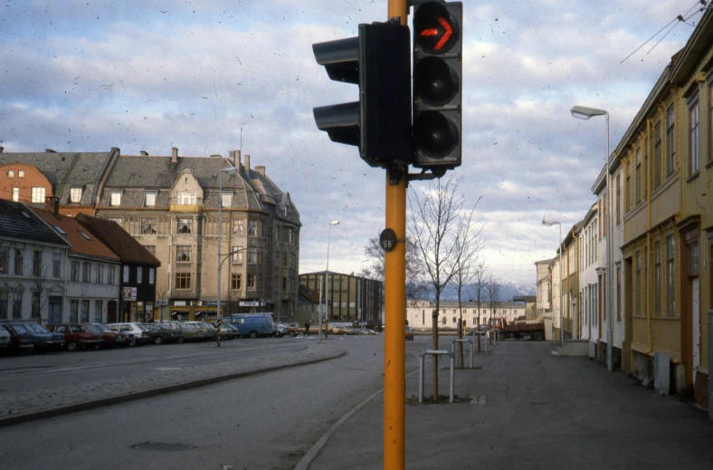 a traffic signal showing red on an empty city street