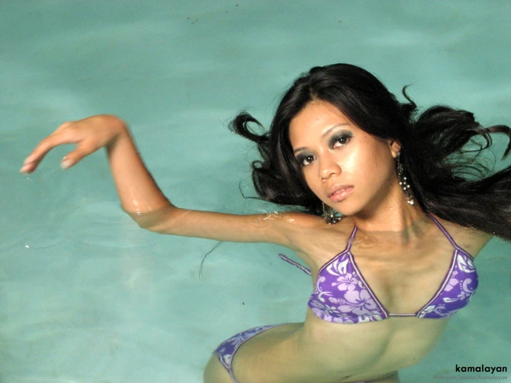 a woman in a purple and purple bikini