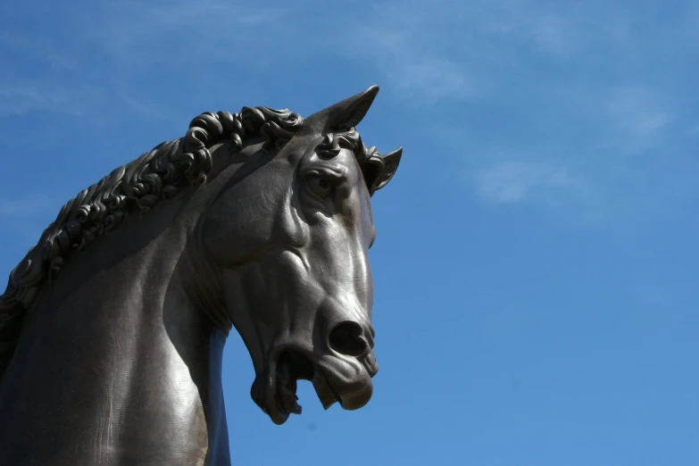 closeup of a horse statue against a blue sky