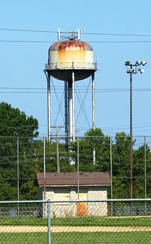 an old rusted water tower surrounded by power lines