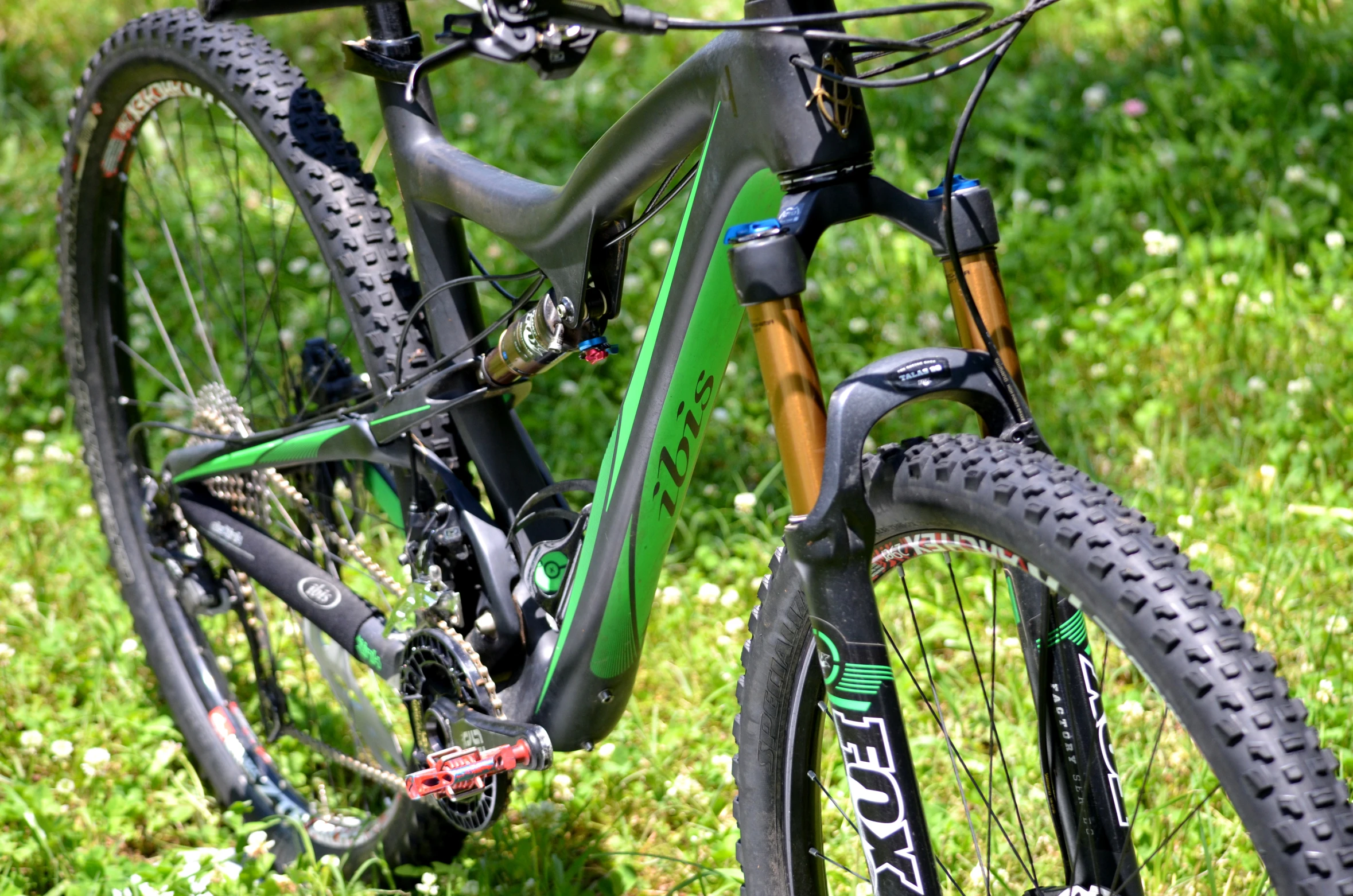 a bicycle with some mud on it parked in the grass