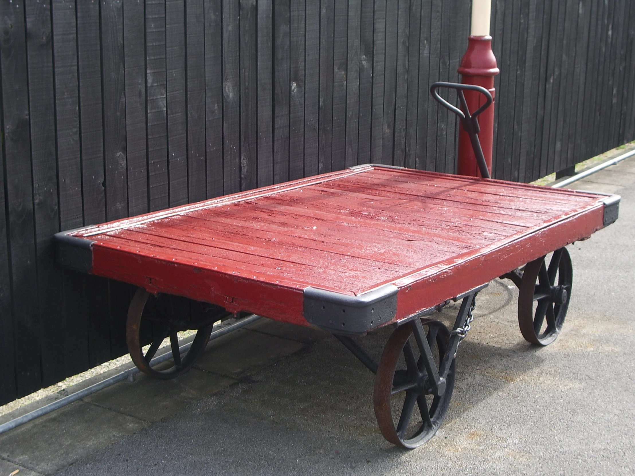 the red wood table is by the fence