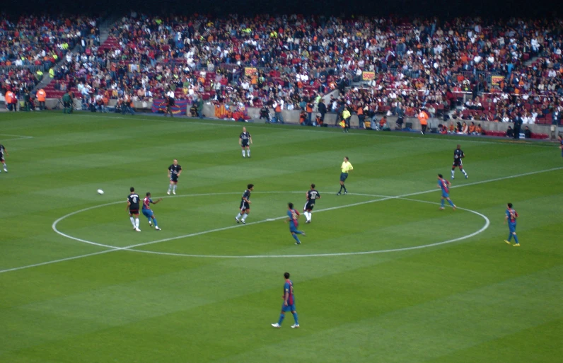 a soccer field with a large crowd watching it