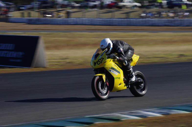 a person on a motorcycle going around a track