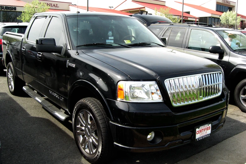 this is a black pick up truck in the lot