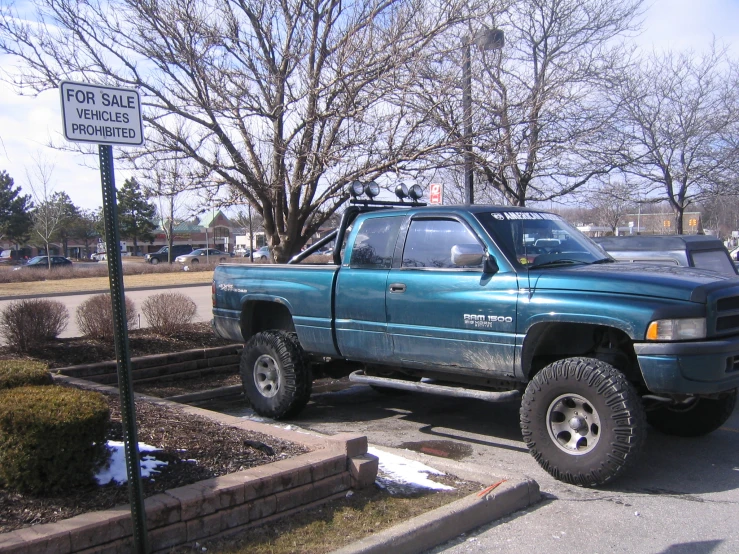 a pickup truck parked in the lot by the roadside