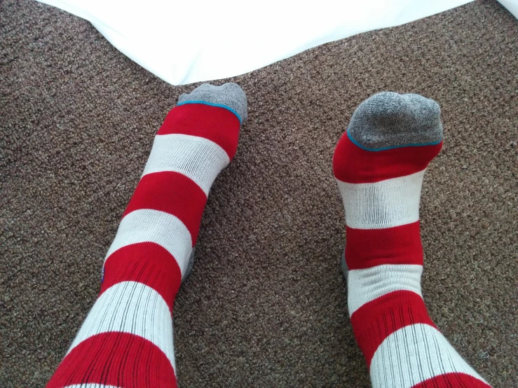 legs in socks with red, white, and blue stripes