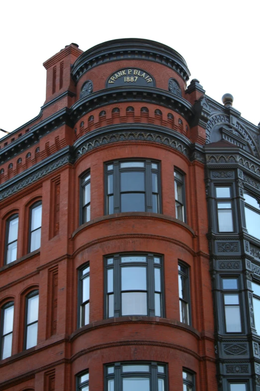 the top of an ornate building with lots of windows