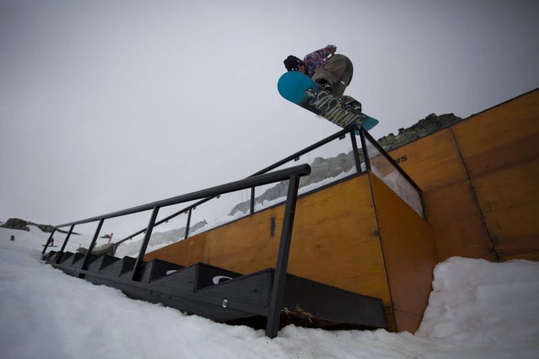 there is a person snowboarding at the top of a stairway