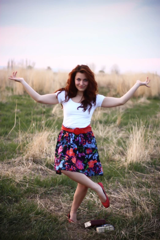 a woman wearing high heels standing in a field