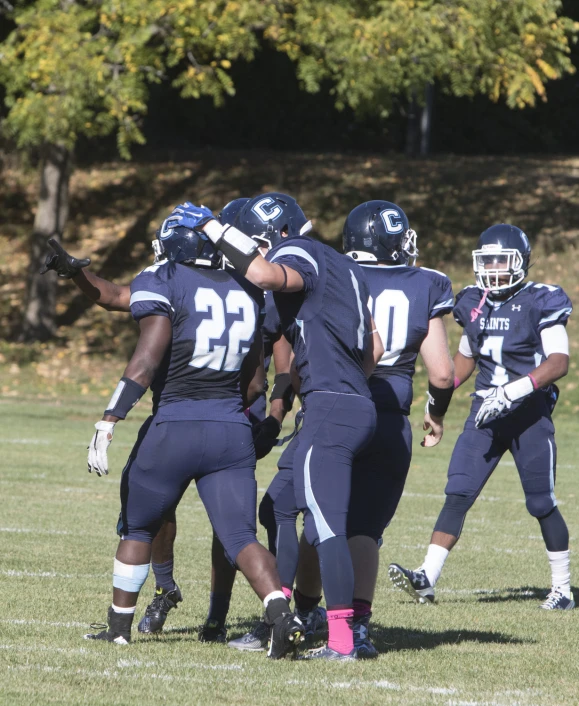 a group of football players are huddled in a huddle