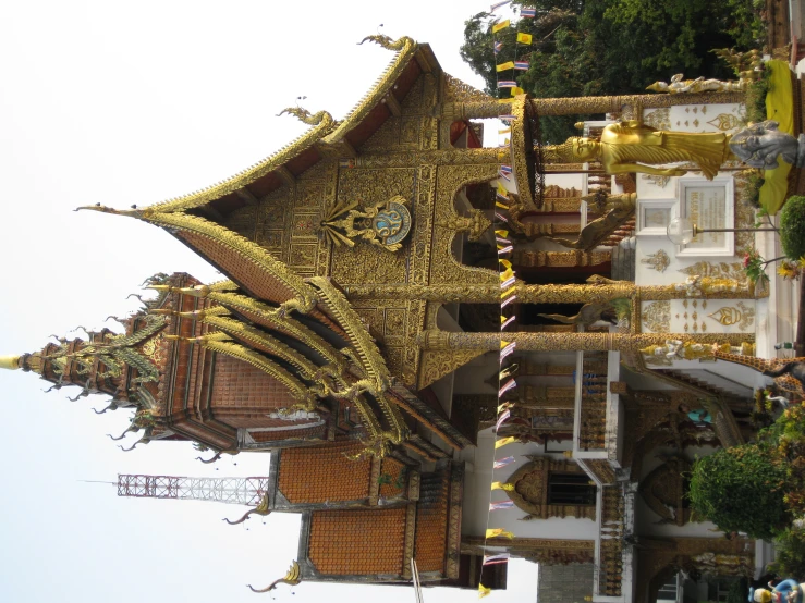 a gold painted house in a city that looks like a shrine