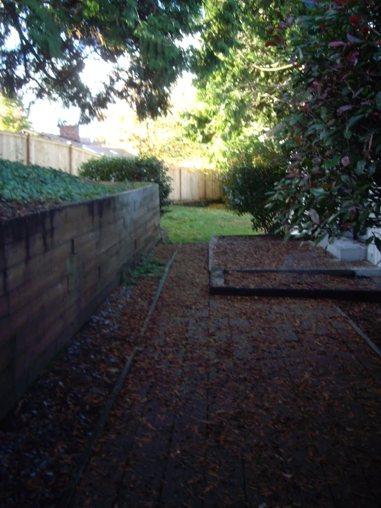 there is a wood fence and garden beds in the backyard