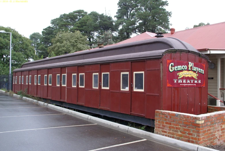 an old train car in the middle of a parking lot