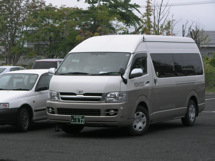 a small van is parked between another vehicle