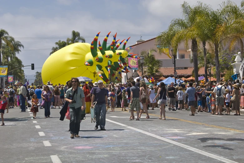 a group of people in the street with balloons