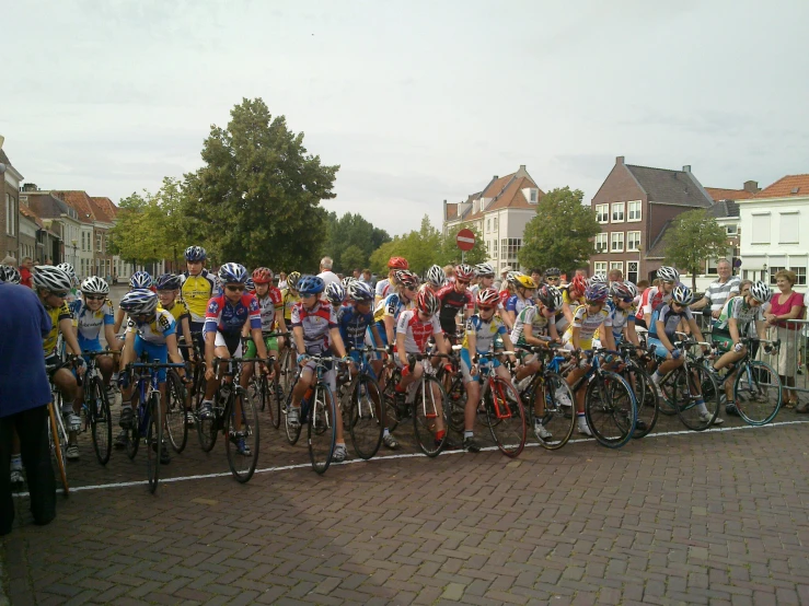 a huge group of bicyclists gathered in the street