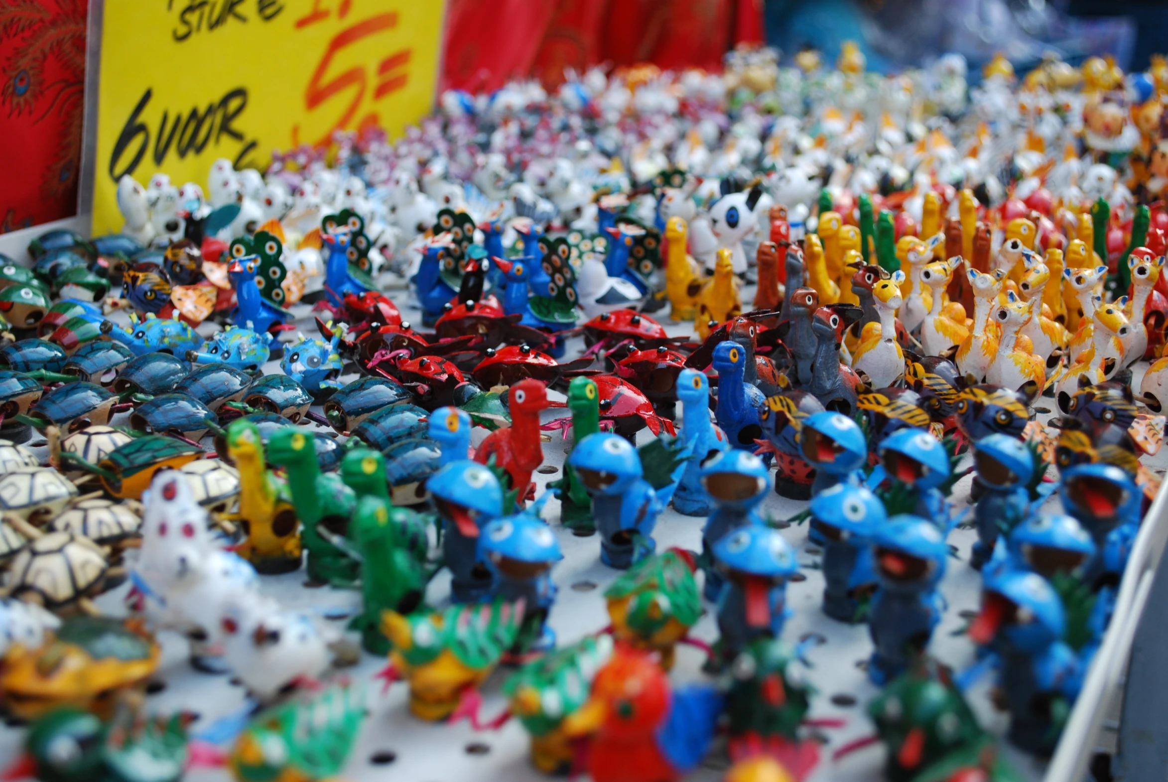 many toy figurines on display at an outdoor market