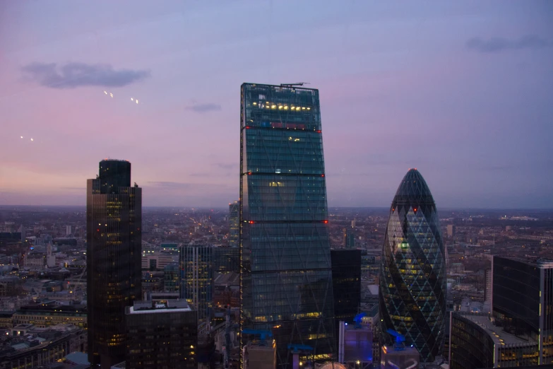 a city at dusk looking down on some large buildings