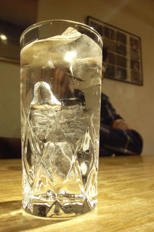 there is a glass of liquid that is sitting on the table