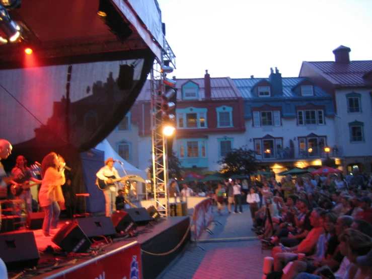 many people watch a man perform a song on stage