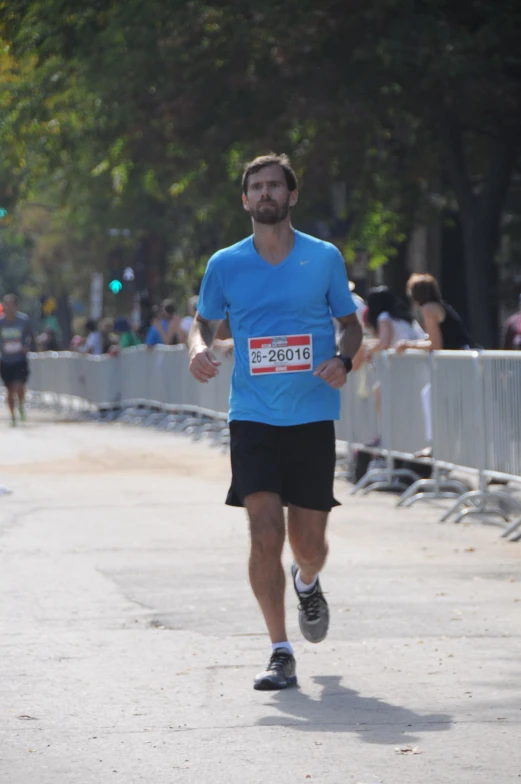 a man wearing blue running in a race