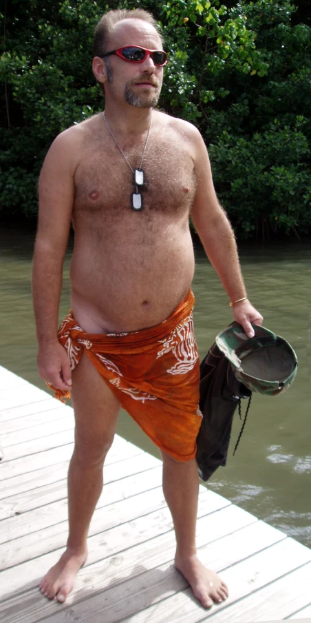 a man standing on a dock near some water