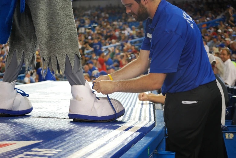 a man waxes the shoe of an opponent on a basketball court