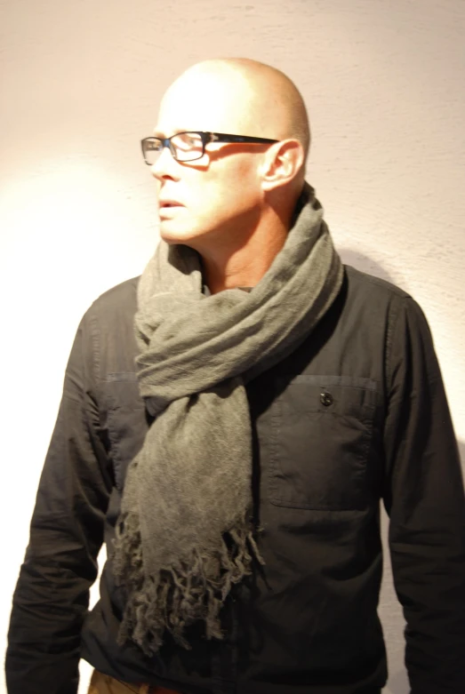 an older man wearing glasses and a scarf