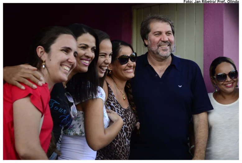 a group of young women and an older man smiling