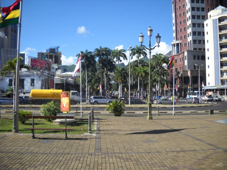 a bench in a public plaza with trees in the background