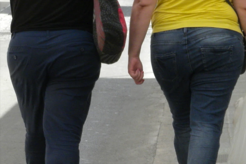 two people walking holding hands and holding onto each other