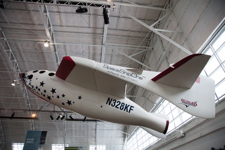 an airplane hanging from the ceiling with a name written on it