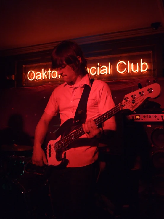 a person playing the bass guitar in the dark