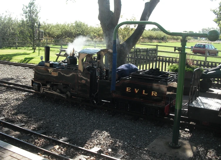 an old - fashioned train that is parked on the tracks