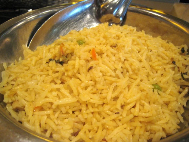 a large bowl with rice and vegetables in it