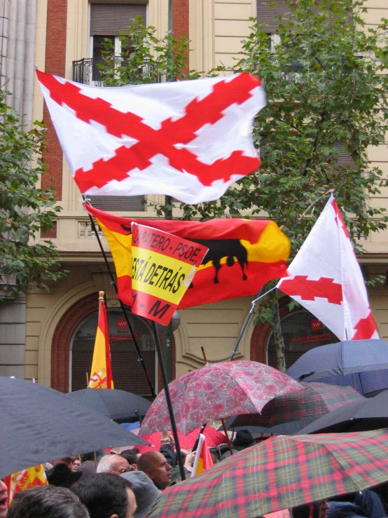 a parade has flags and banners of different colors