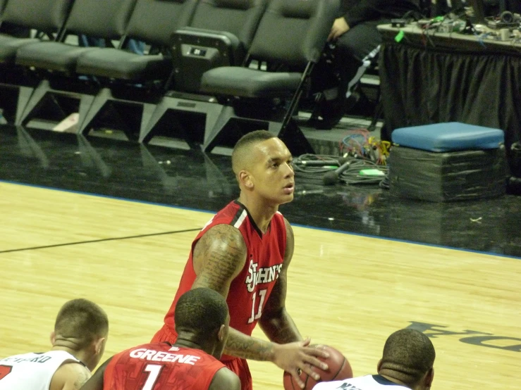 a group of people playing basketball in front of a crowd