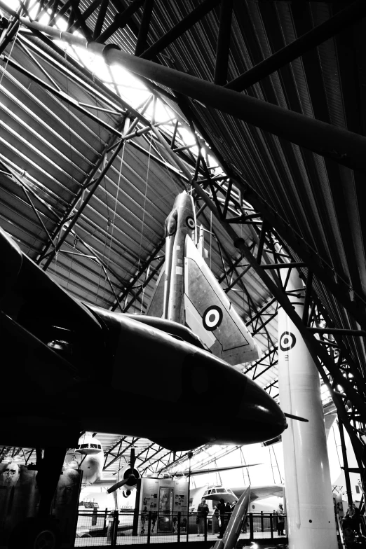 the planes are hanging from the ceiling in a hangar