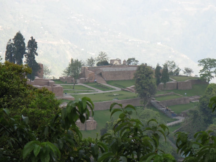 an architectural structure is shown with trees near by