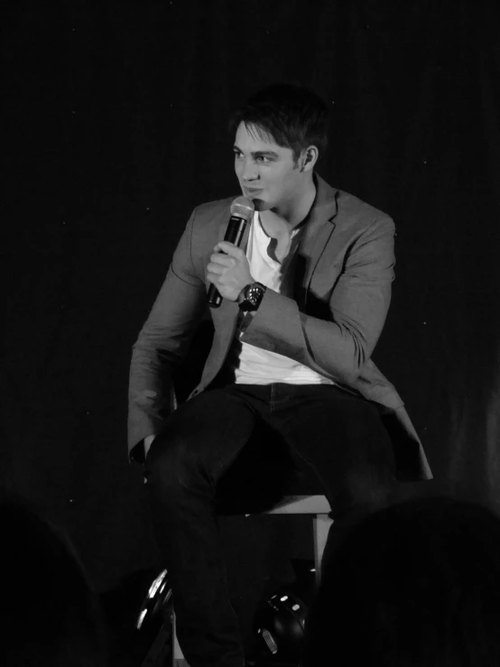 a person on a stage talking into a microphone