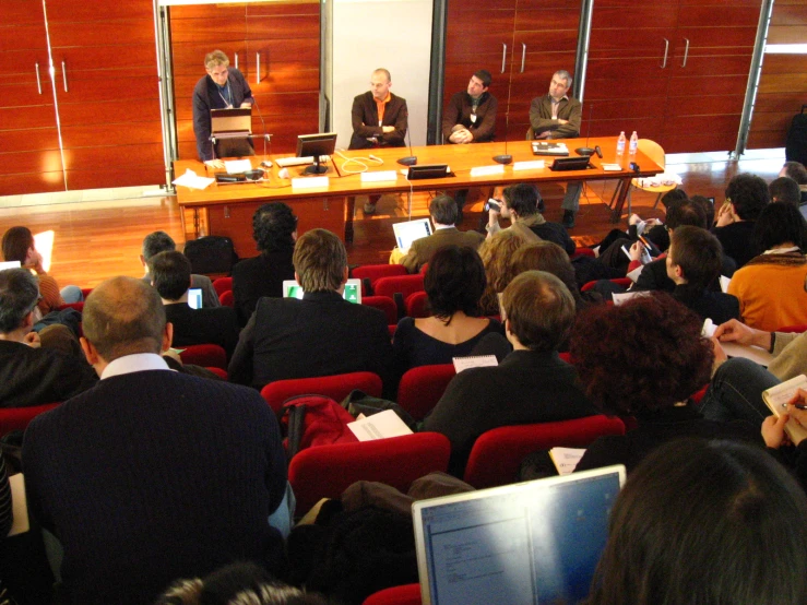 people sitting at tables and having a meeting