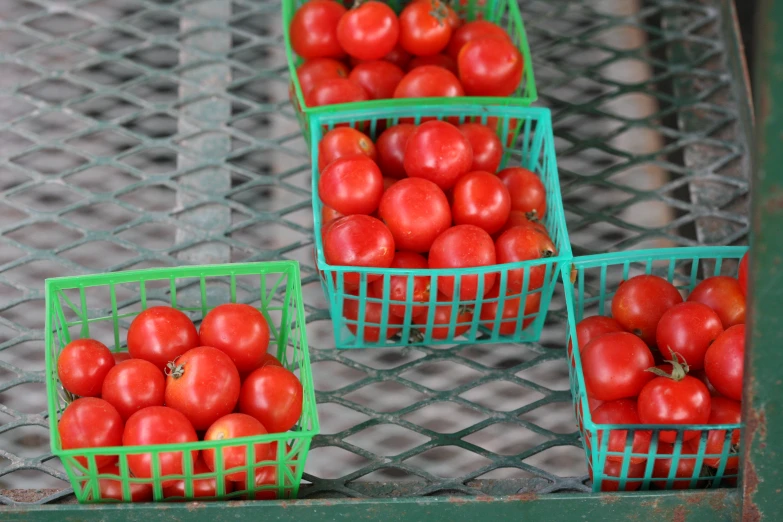 green metal baskets holding apples of various varieties