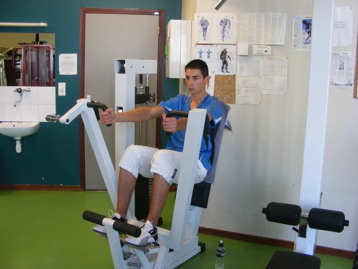 man using exercise equipment inside of building