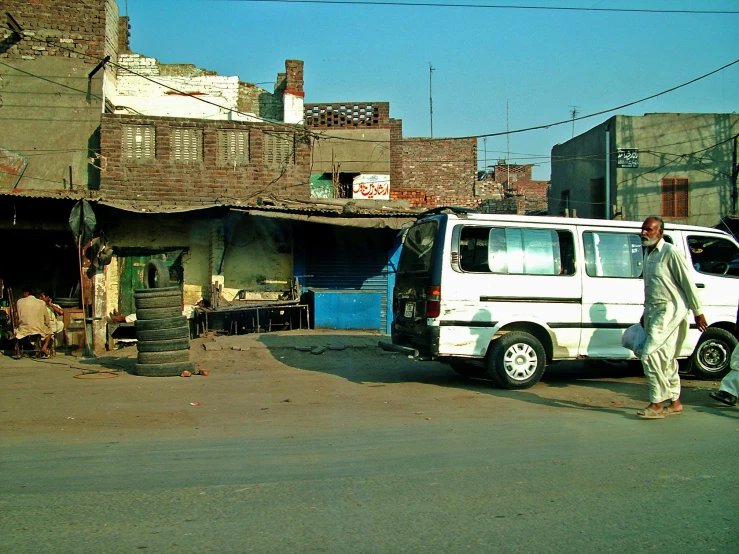 man standing in front of his van on the street