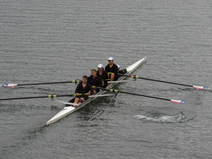 two rowing teams racing along in a large body of water