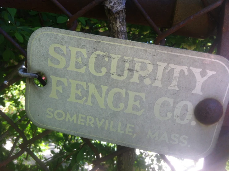 a sign that says security fence co, somewhere in the usa